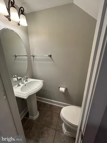 a bathroom with a sink a toilet and mirror