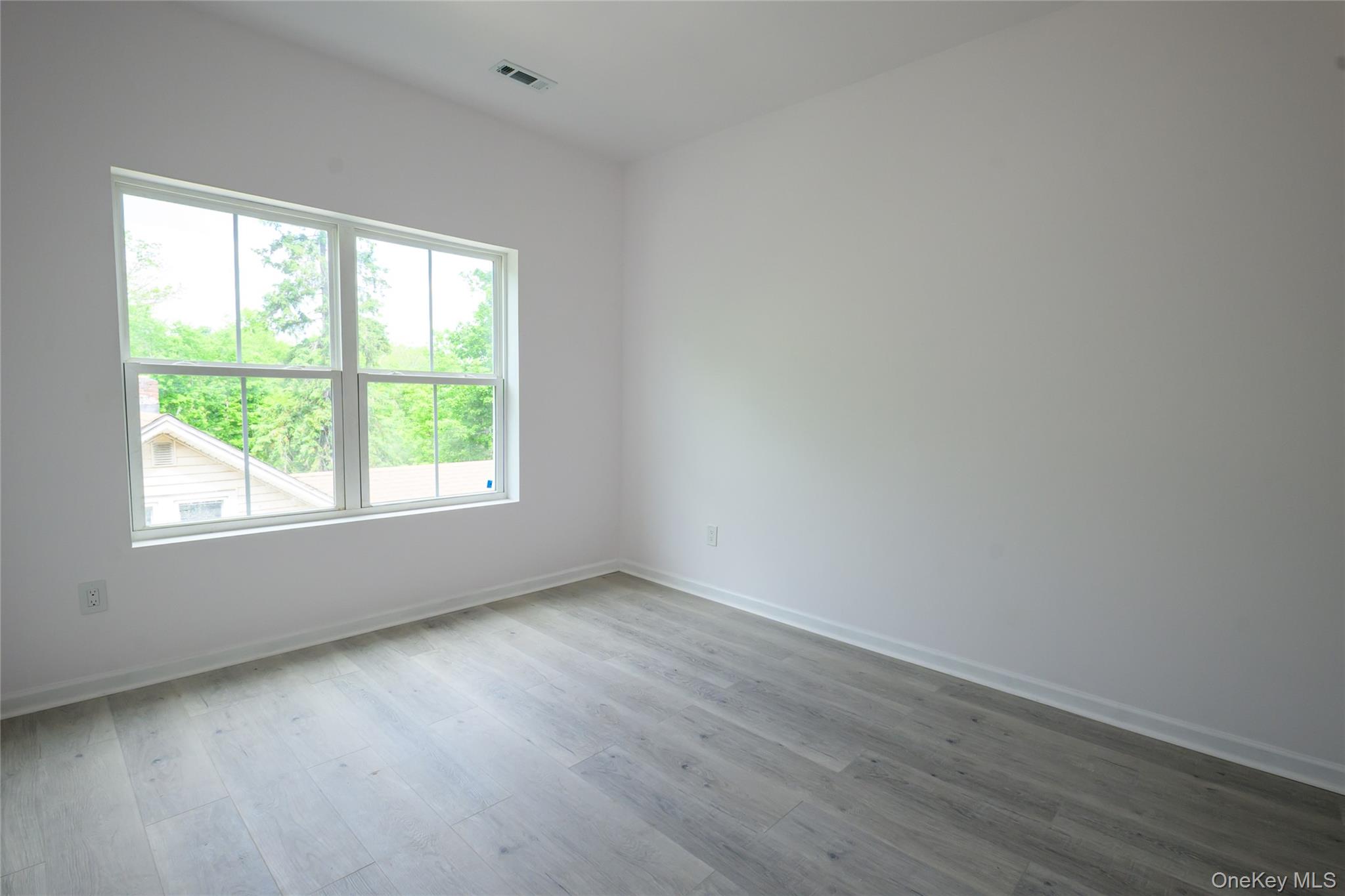 81 Silver Lake Sctn Road Middletown, NY 10940 - Photo 24 of 37 an empty room with wooden floor and windows