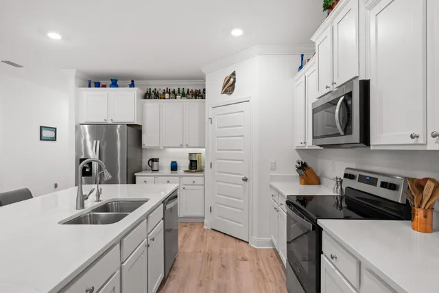 a kitchen that has a sink a stove and refrigerator