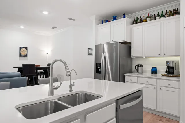 a kitchen with refrigerator a sink and cabinets