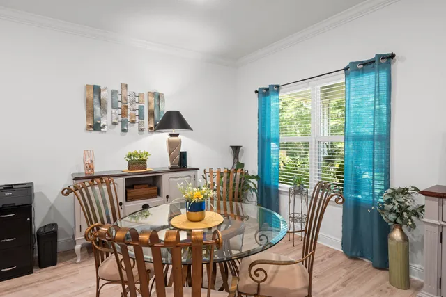 a view of a dining room with furniture and window