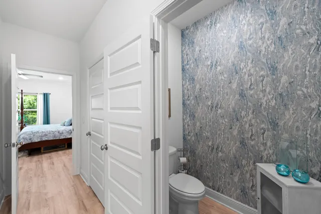 a bathroom with a granite countertop sink a toilet and a shower