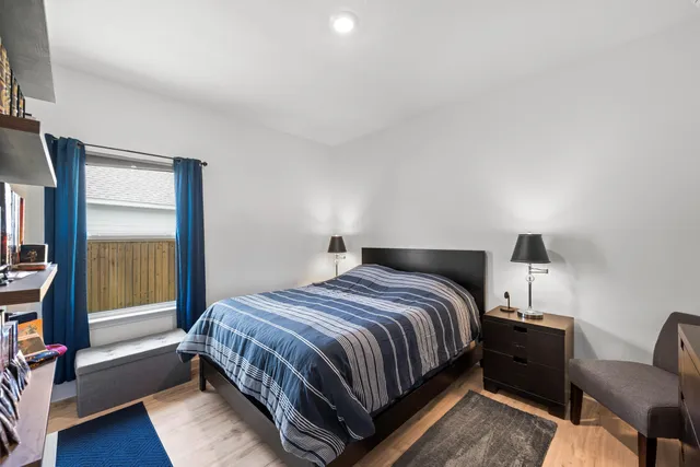 a bedroom with a bed and a window