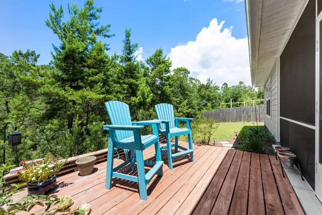 a view of a chairs and table in the balcony with potted plants
