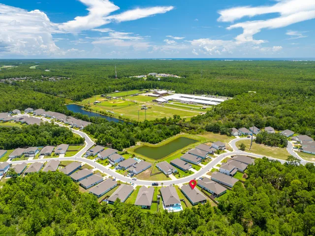 an aerial view of residential houses with outdoor space