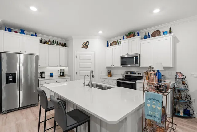 a kitchen with stainless steel appliances a refrigerator and a stove top oven