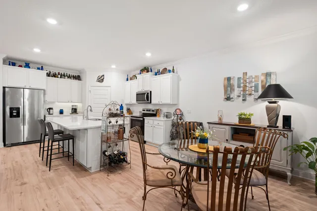 a view of a dining room with furniture and wooden floor