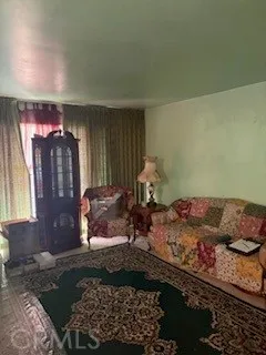 a living room filled with furniture and a chandelier