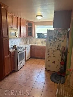 a kitchen with a stove top oven sink and cabinets