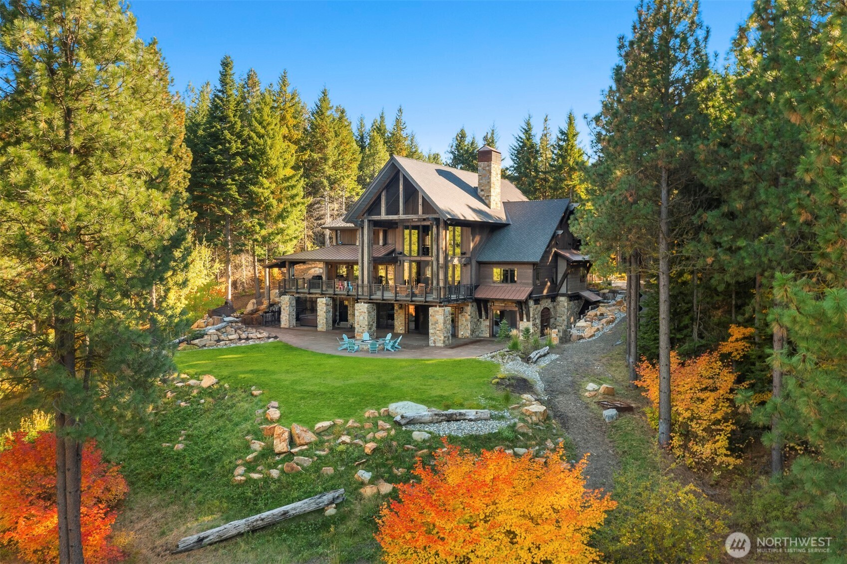a view of a house with a big yard potted plants and large tree
