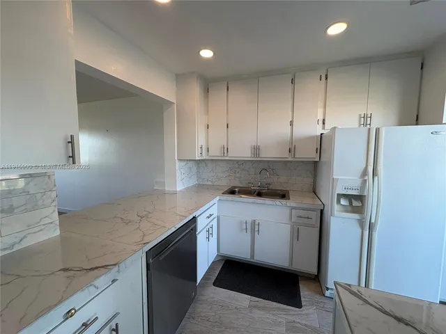 a kitchen with a sink stove and refrigerator
