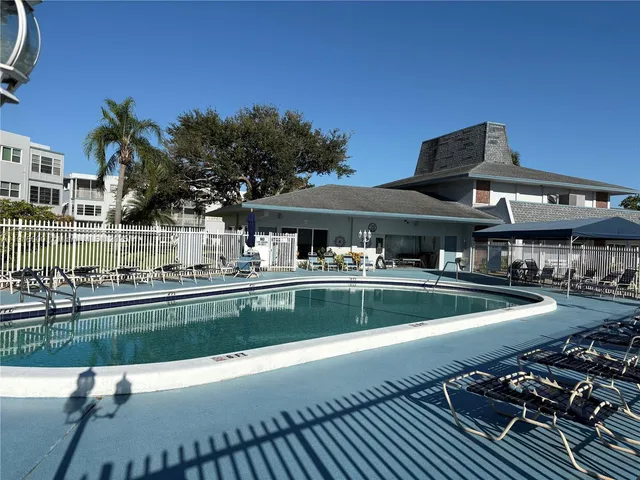 a view of a swimming pool with an outdoor seating