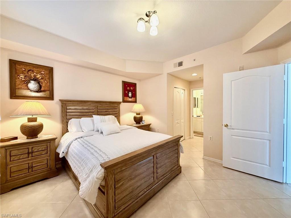 8450 Kingbird Loop, Unit 431 Estero, FL 33967 - Photo 16 of 47 Bedroom with a closet, light tile patterned floors, and ensuite bath