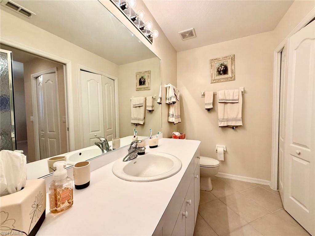 8450 Kingbird Loop, Unit 431 Estero, FL 33967 - Photo 19 of 47 Bathroom featuring vanity, a closet, and light tile patterned floors