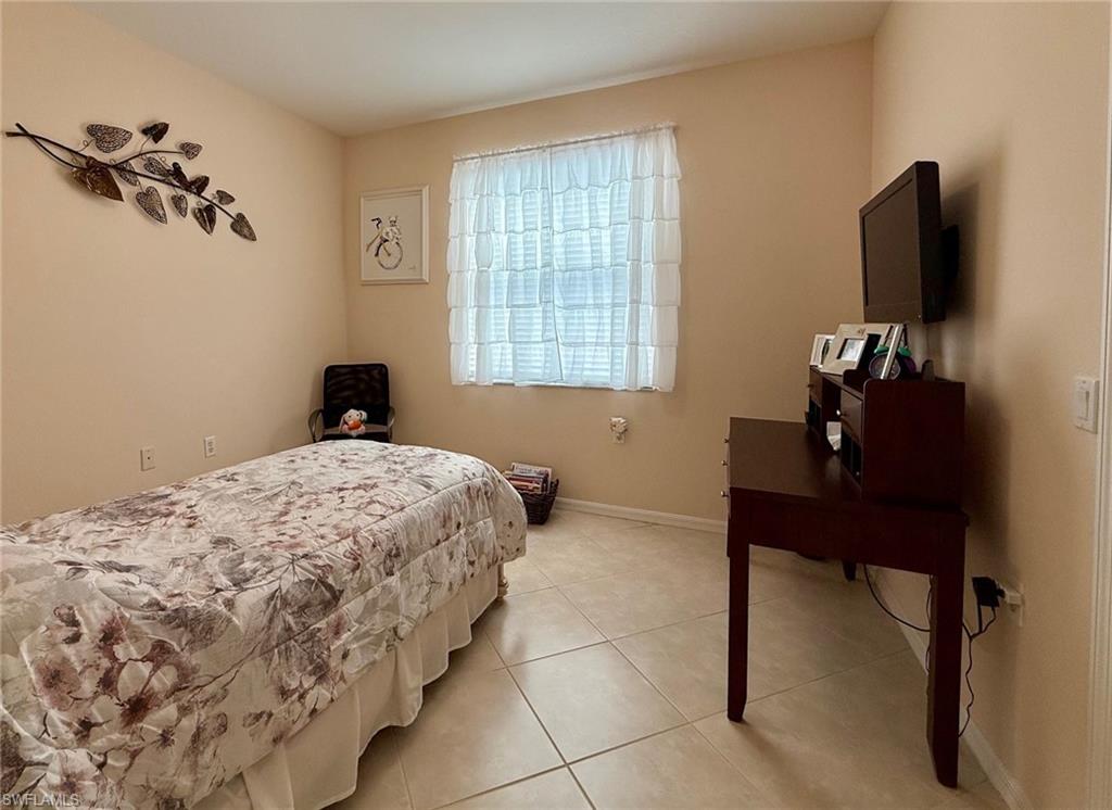 8450 Kingbird Loop, Unit 431 Estero, FL 33967 - Photo 30 of 47 Bedroom featuring tile patterned floors and baseboards
