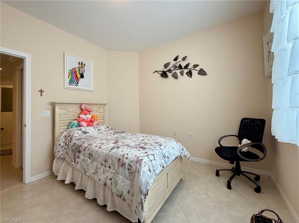 8450 Kingbird Loop, Unit 431 Estero, FL 33967 - Photo 31 of 47 Bedroom featuring baseboards and light tile patterned floors