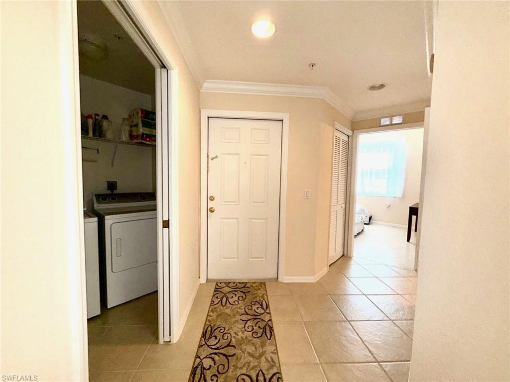 8450 Kingbird Loop, Unit 431 Estero, FL 33967 - Photo 33 of 47 Corridor featuring ornamental molding, light tile patterned floors, independent washer and dryer, and recessed lighting