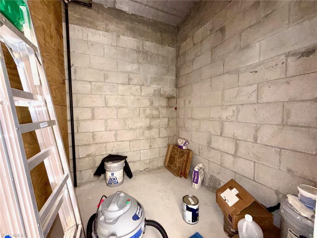 8450 Kingbird Loop, Unit 431 Estero, FL 33967 - Photo 36 of 47 Bathroom with concrete block wall and concrete floors