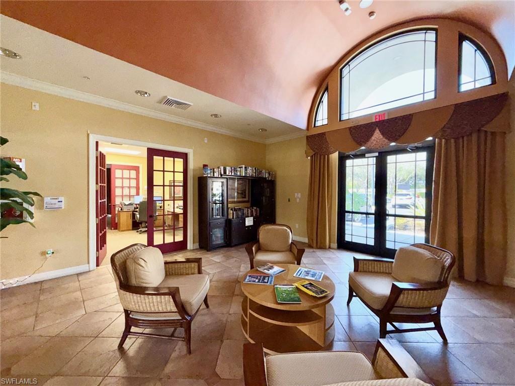 8450 Kingbird Loop, Unit 431 Estero, FL 33967 - Photo 41 of 47 Living area featuring french doors, lofted ceiling, and ornamental molding