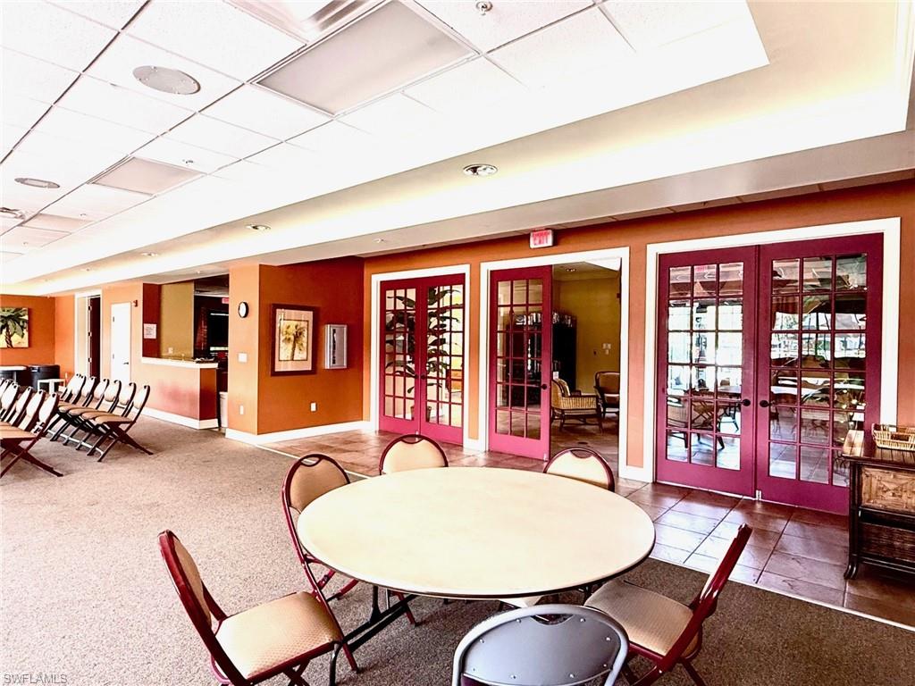 8450 Kingbird Loop, Unit 431 Estero, FL 33967 - Photo 43 of 47 Dining area featuring french doors, a paneled ceiling, and carpet flooring