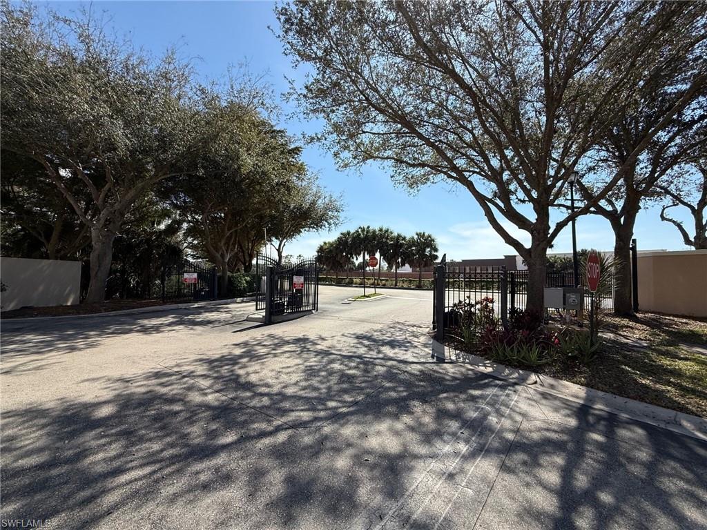 8450 Kingbird Loop, Unit 431 Estero, FL 33967 - Photo 47 of 47 View of asphalt street featuring a gated entry, a gate, and curbs