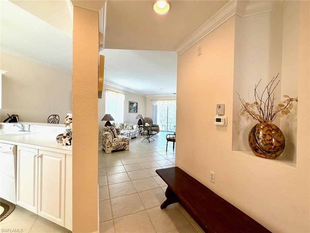 8450 Kingbird Loop, Unit 431 Estero, FL 33967 - Photo 10 of 47 Corridor with ornamental molding, light tile patterned floors, and recessed lighting