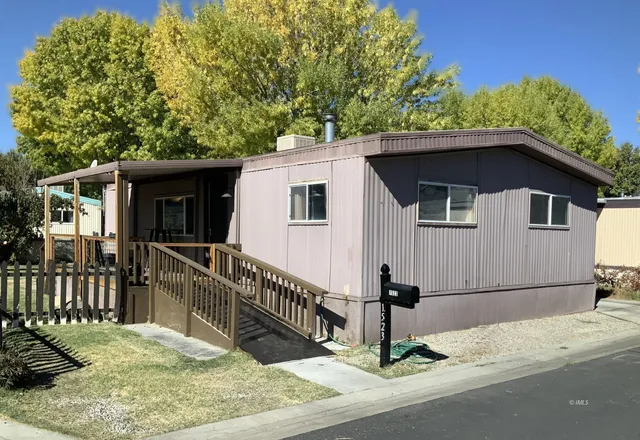 a view of a house with wooden fence