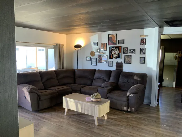 a living room with furniture and a bookshelf