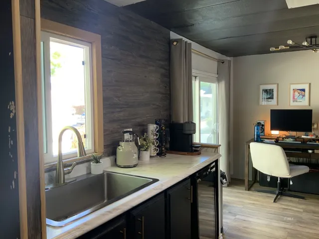 a kitchen with a sink cabinets and dining table