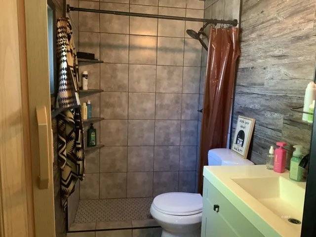 a bathroom with a sink toilet and shower