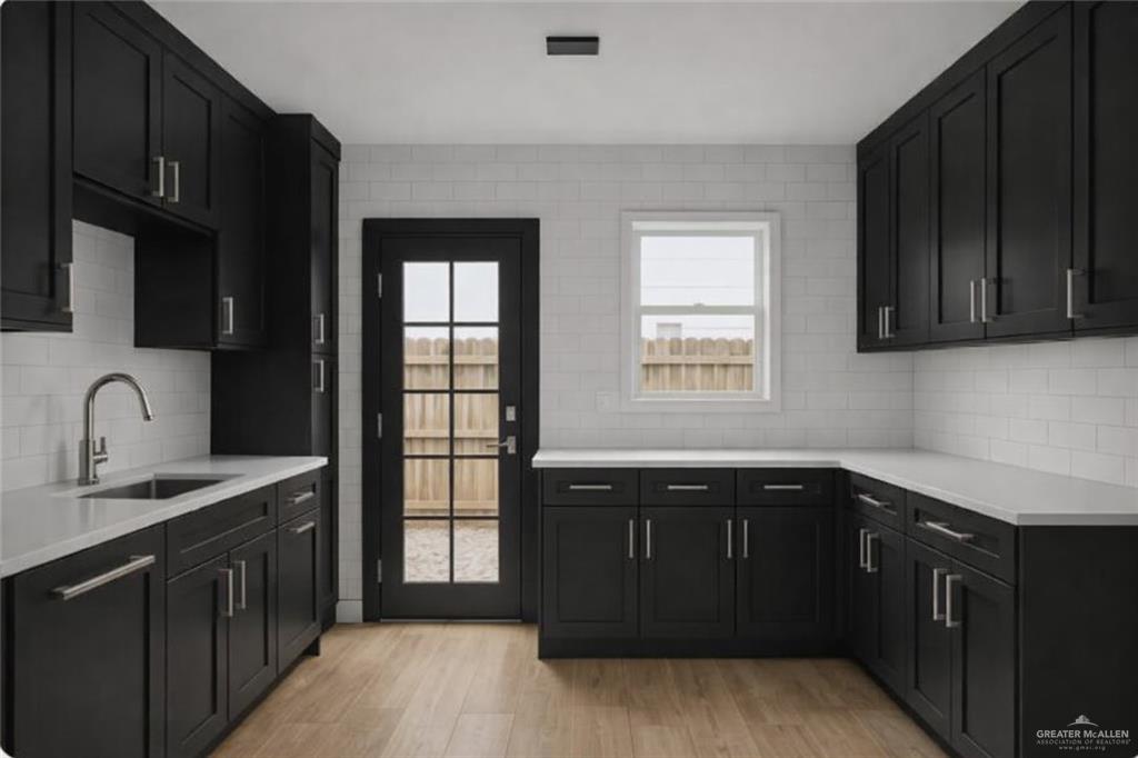 188 Farrell Road, Unit 1 Weslaco, TX 78596 - Photo 3 of 12 a kitchen with a sink stove and cabinets