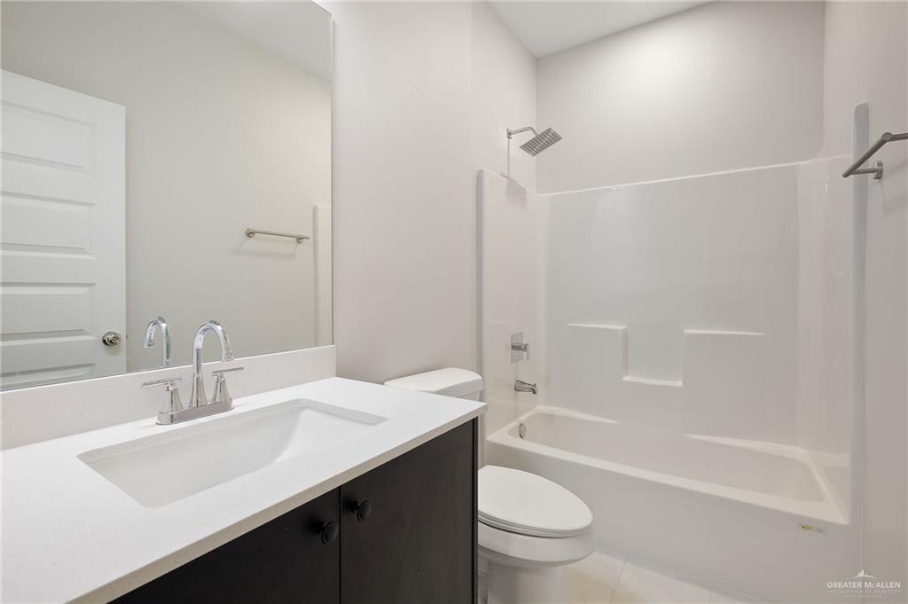 188 Farrell Road, Unit 1 Weslaco, TX 78596 - Photo 7 of 12 a bathroom with a sink a toilet and shower