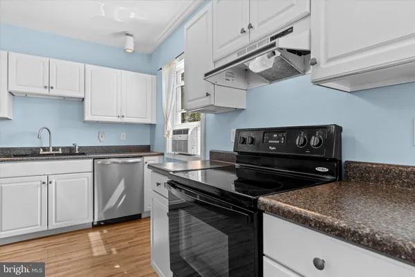 a kitchen with granite countertop a stove and a sink