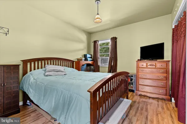 a bedroom with furniture and a flat screen tv