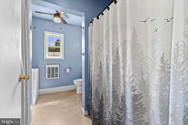a view of a bathroom with a shower curtain