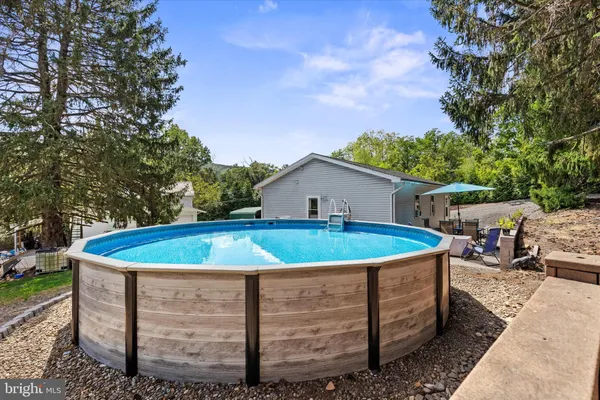 a view of a house with a swimming pool and a yard