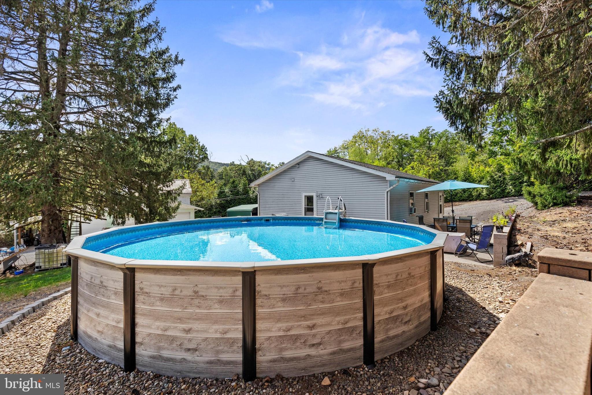 239 Hill Street Lykens, PA 17048 - Photo 19 of 43 a view of a house with a swimming pool and a yard