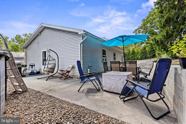 a view of a workspace with furniture and umbrella