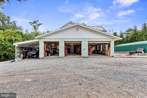 a view of a house with a yard and potted plants