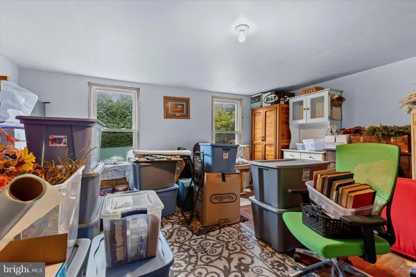 a room with furniture a rug workspace and windows