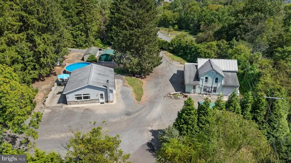 an aerial view of a house with outdoor space
