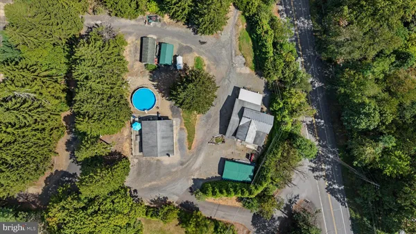 an aerial view of a house with outdoor space and street view