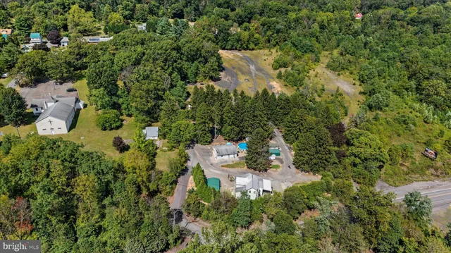 a view of a lush green field with a building in the background