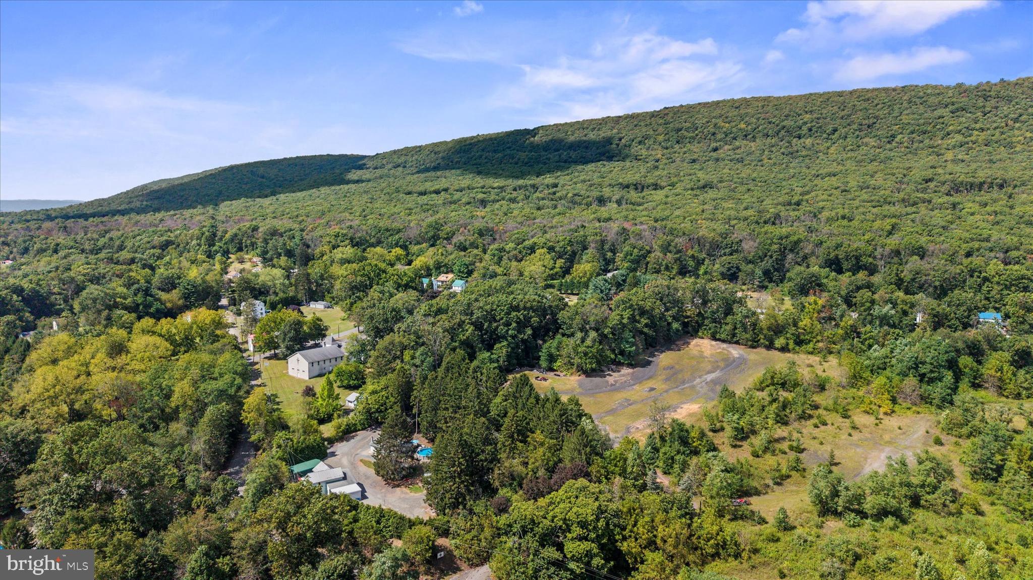 239 Hill Street Lykens, PA 17048 - Photo 40 of 43 a view of a lush green field with a building in the background