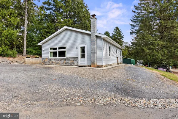 a view of house with trees in the background