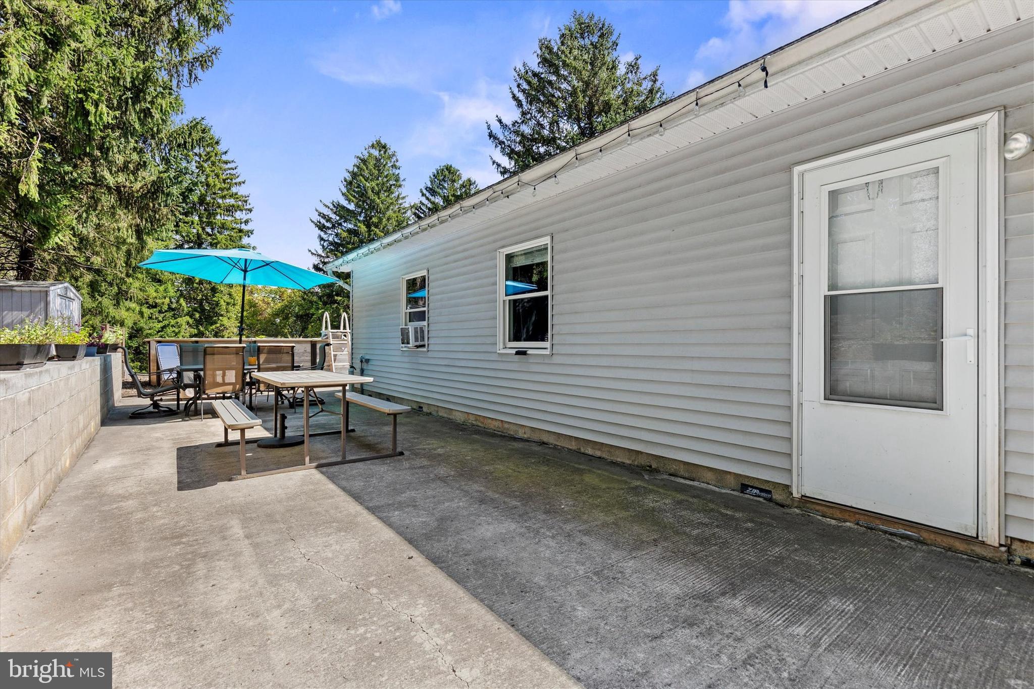 239 Hill Street Lykens, PA 17048 - Photo 5 of 43 a view of a patio with table and chairs under an umbrella with a barbeque