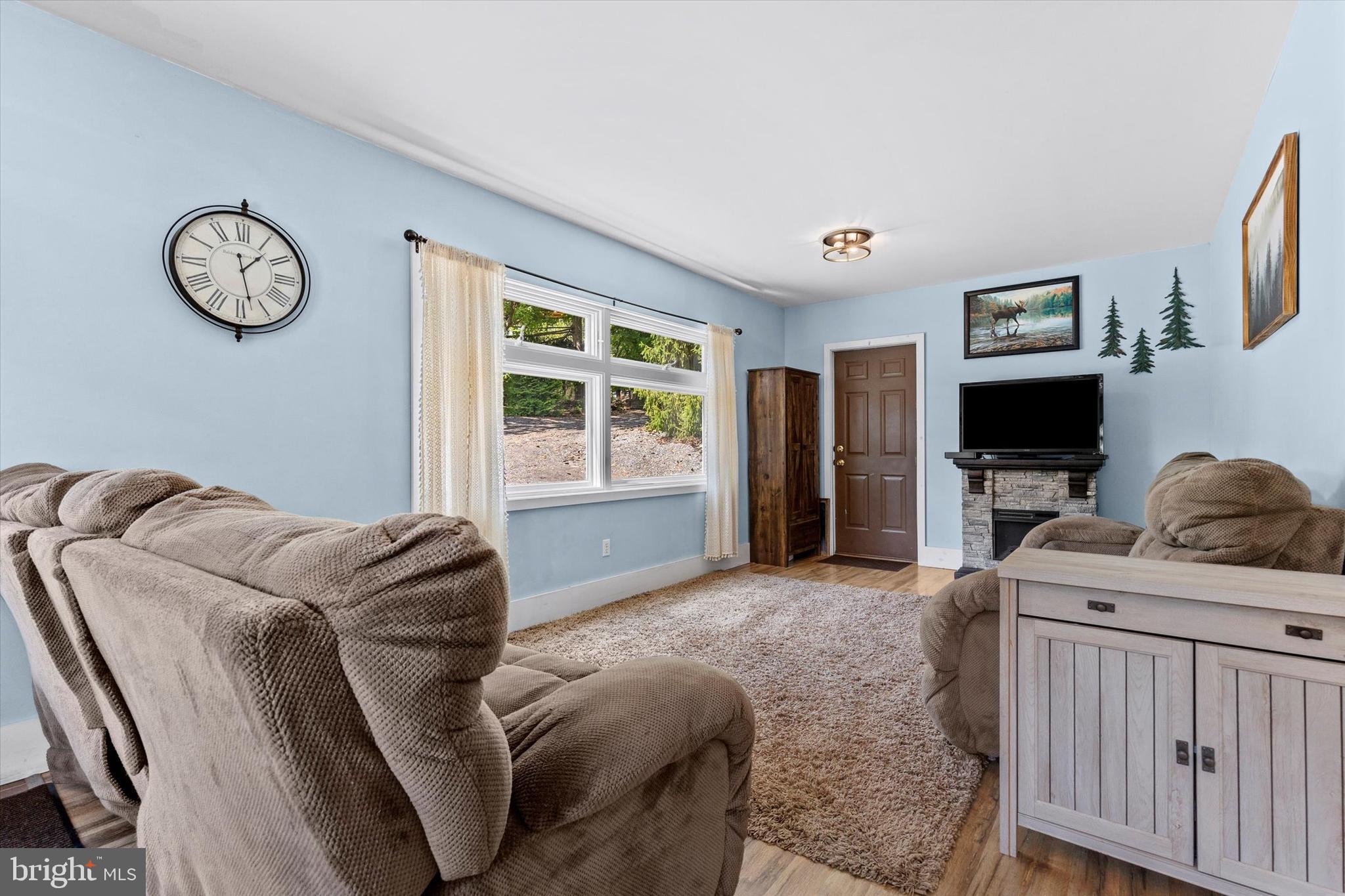 239 Hill Street Lykens, PA 17048 - Photo 7 of 43 a living room with furniture a flat screen tv and a window
