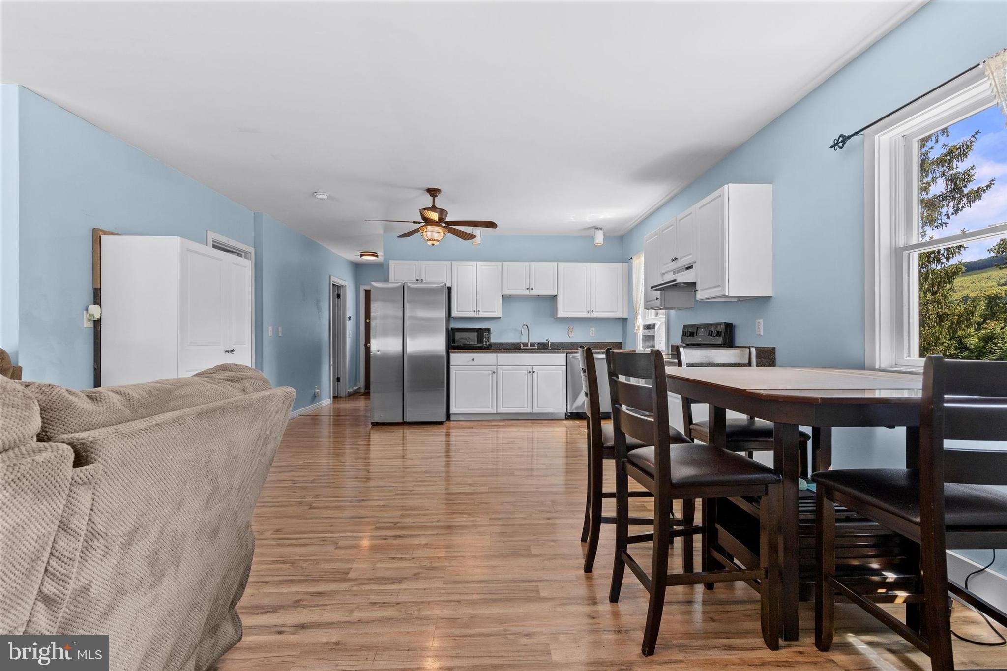 239 Hill Street Lykens, PA 17048 - Photo 9 of 43 a living room with stainless steel appliances furniture a dining table and kitchen view