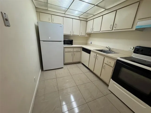 a kitchen with cabinets and appliances