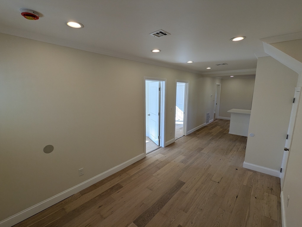 296 Fulton Street, Unit 1 Medford, MA 02155 - Photo 7 of 19 a view of a hallway with wooden floor